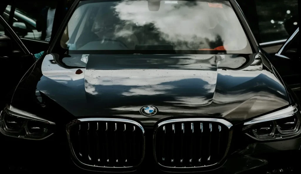 Close-up of a black BMW luxury car front grille and headlights.